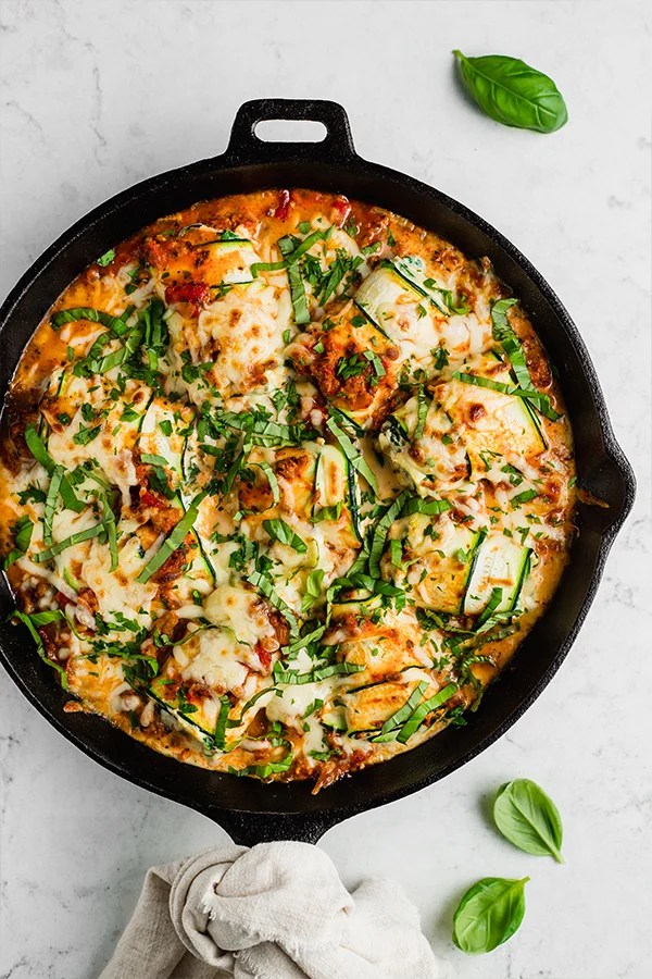 Skillet full of zucchini roll ups.