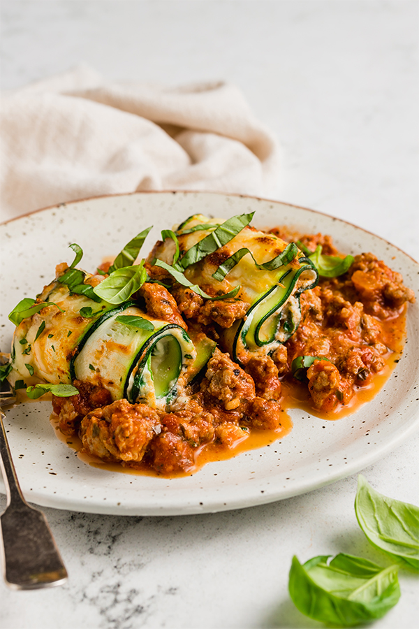 Zucchini roll ups on a plate.