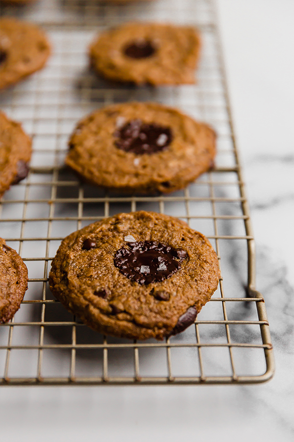 Up close image of baked flourless almond butter cookies on a cooling rack