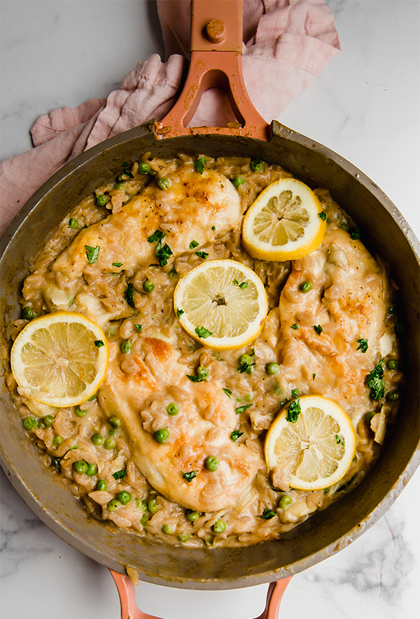 Lemon chicken with orzo cooked in a pan