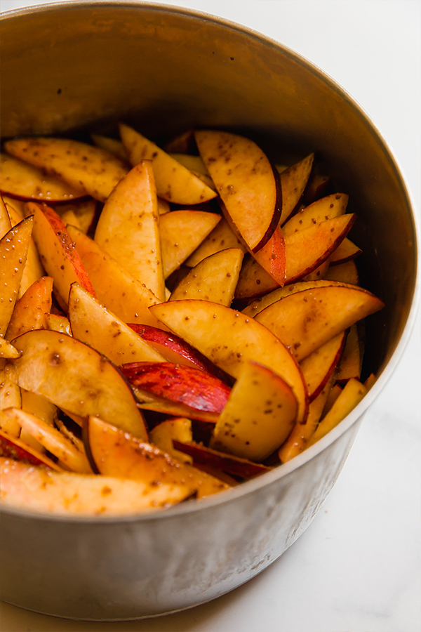 Slices peaches mixture in a metal pot