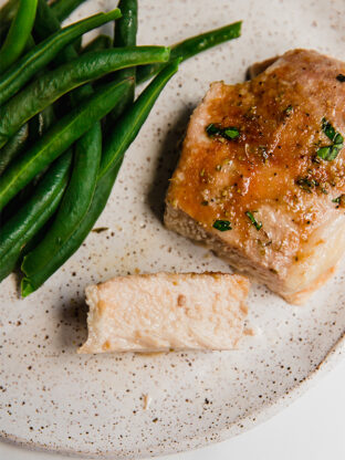 Slice of pork chop on a plate.