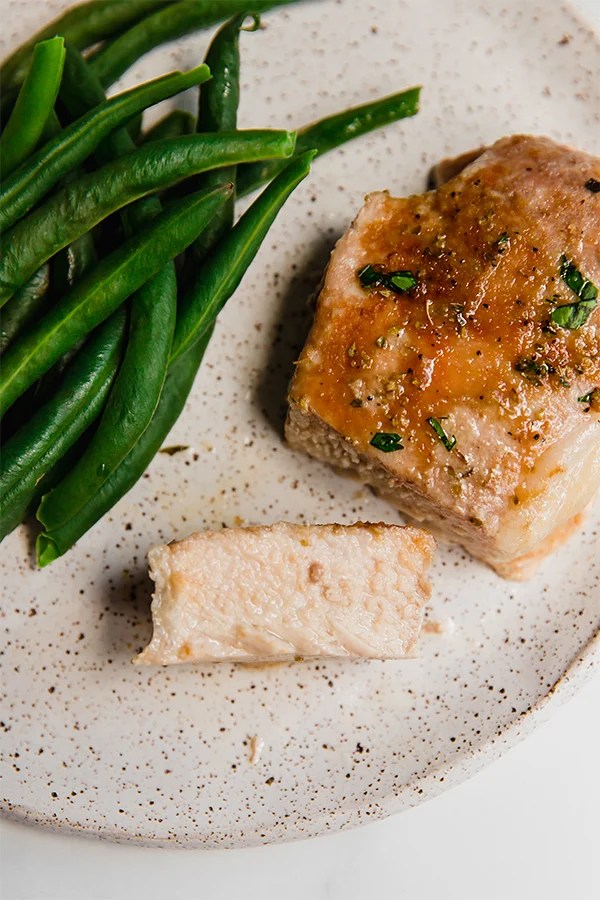 Slice of pork chop on a plate.
