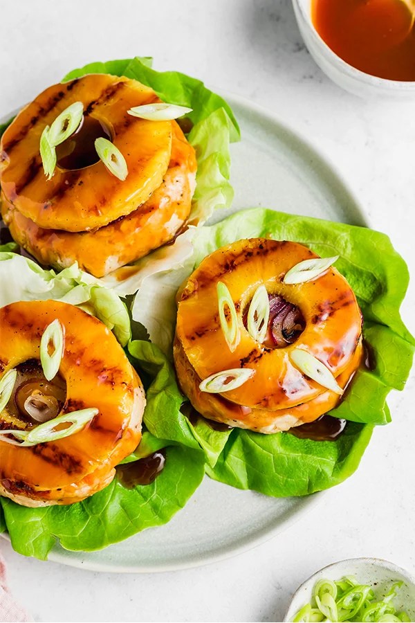 Sweet and sour chicken burgers on lettuce.