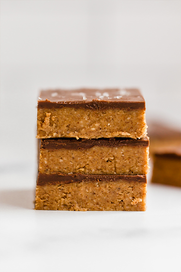 3 almond butter bars stacked on counter