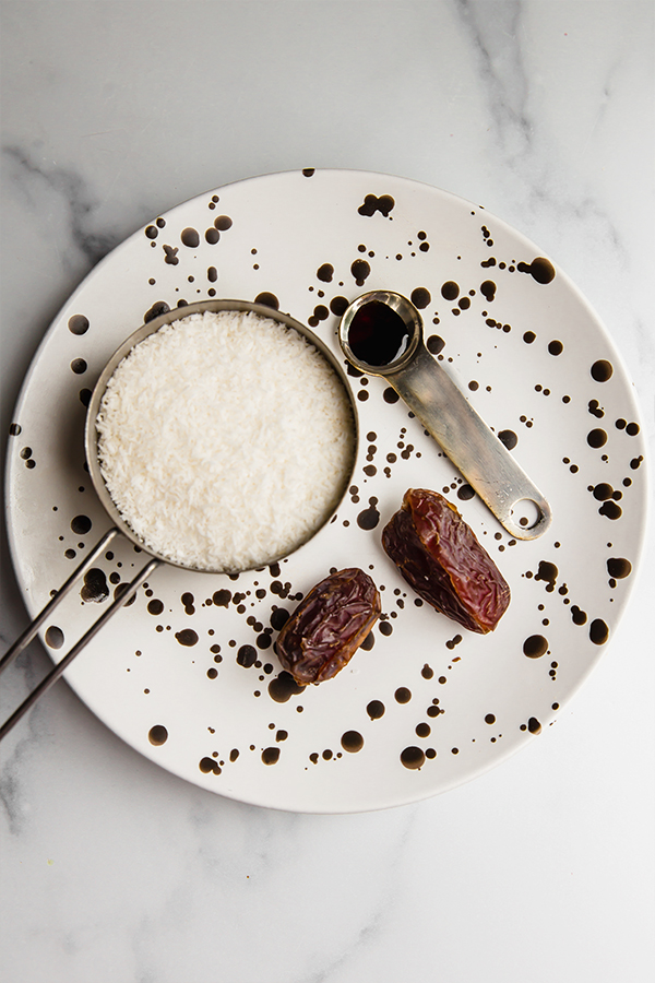 Shredded coconut, dates, and vanilla extract.