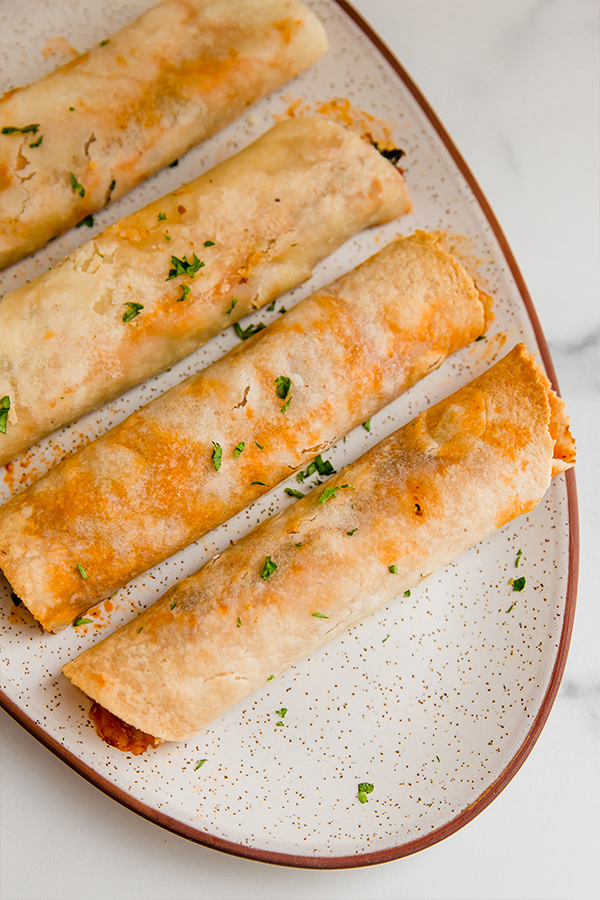 Cooked taquitos served on a plater