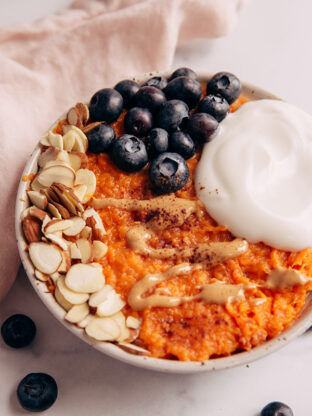 Sweet potato breakfast bowl with nuts and blueberries.