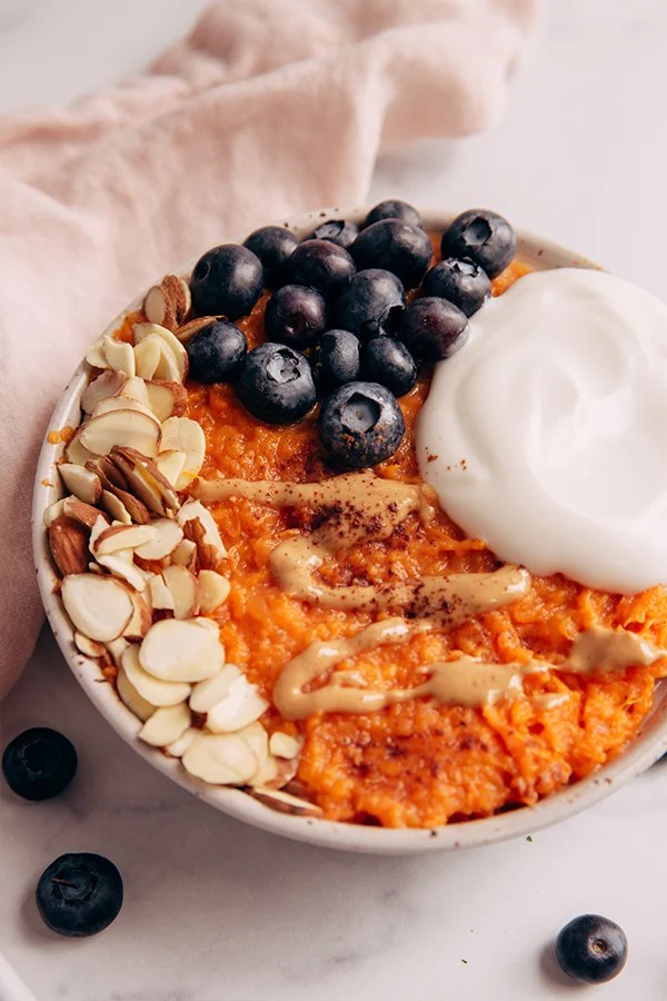 Sweet potato breakfast bowl with nuts and blueberries.
