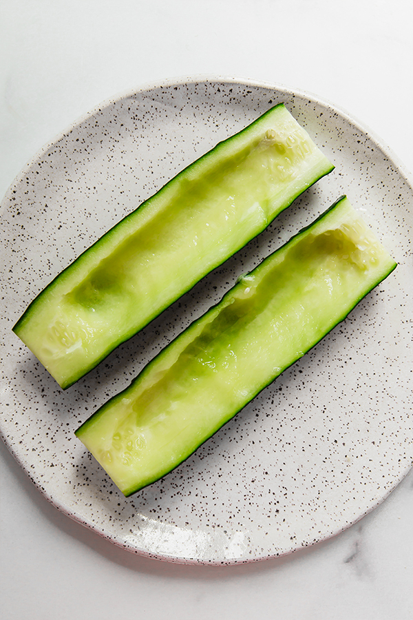 Hollowed-out cucumbers on a plate.
