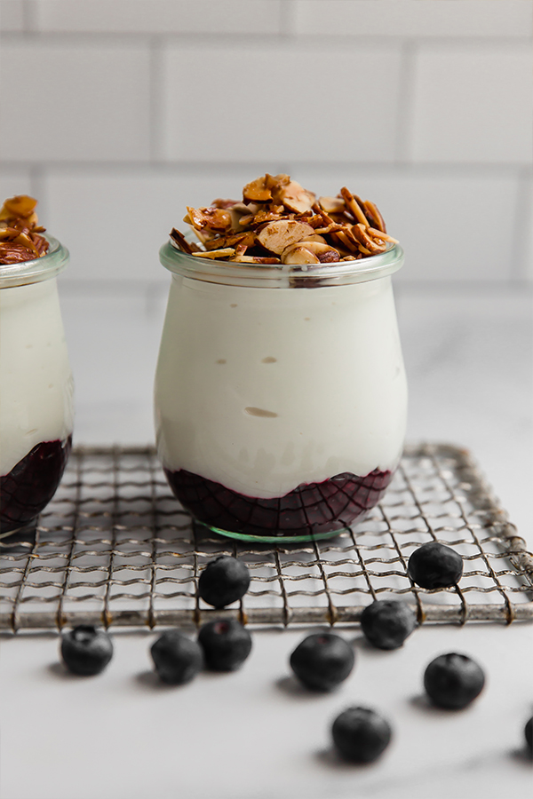 Jar with fruit, then yogurt, then almonds.