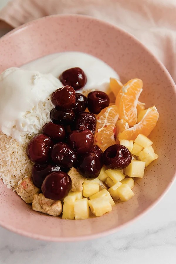 Ambrosia salad ingredients in bowl ready to be mixed