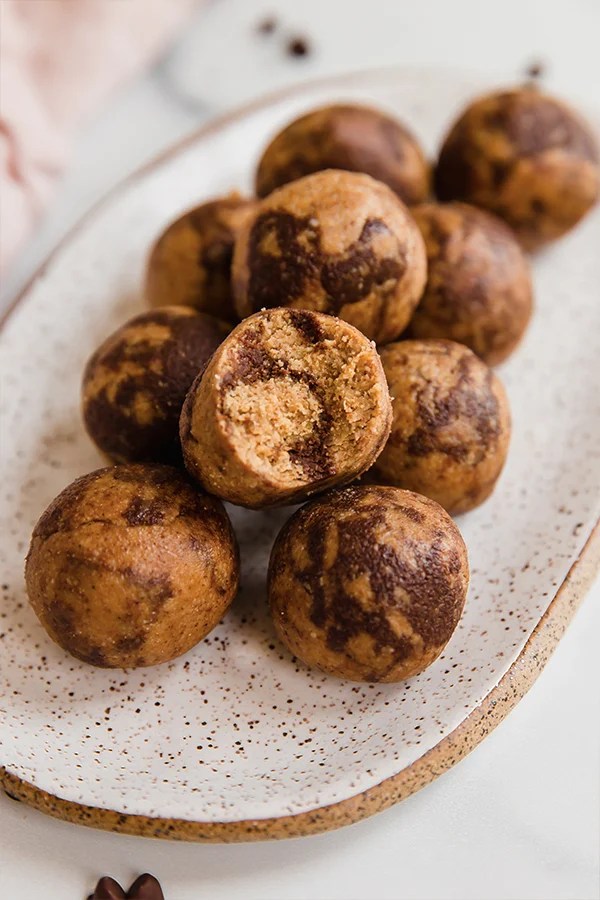 Chocolate swirl energy bites piled on a platter.