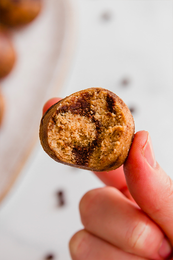 Person holding a chocolate swirl energy bite.