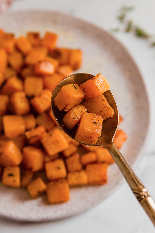 cubed butternut squash on a spoon