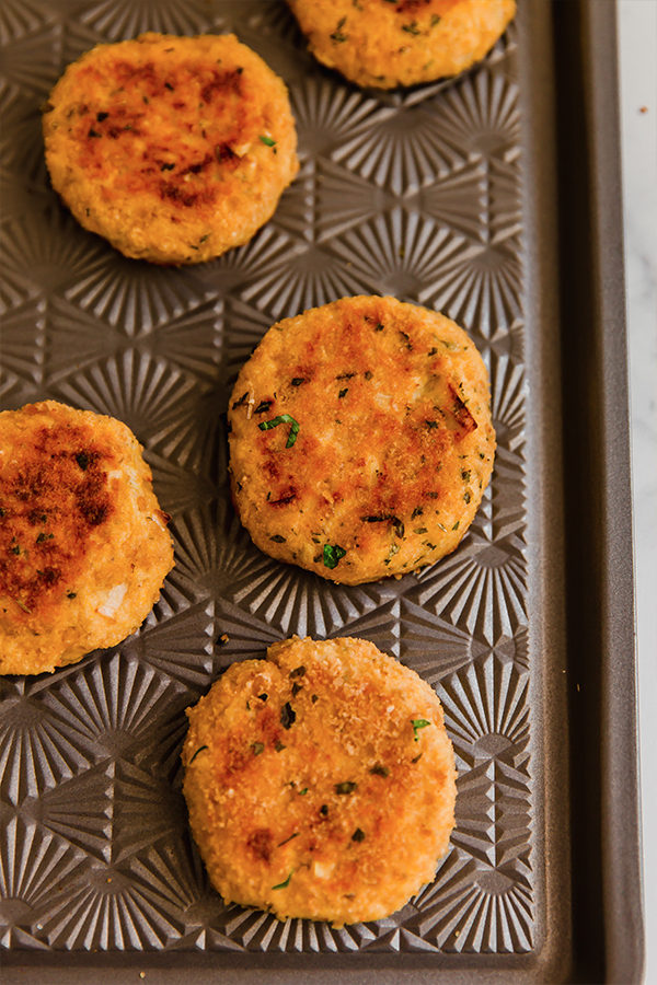 Butternut salmon cakes on a baking sheet.