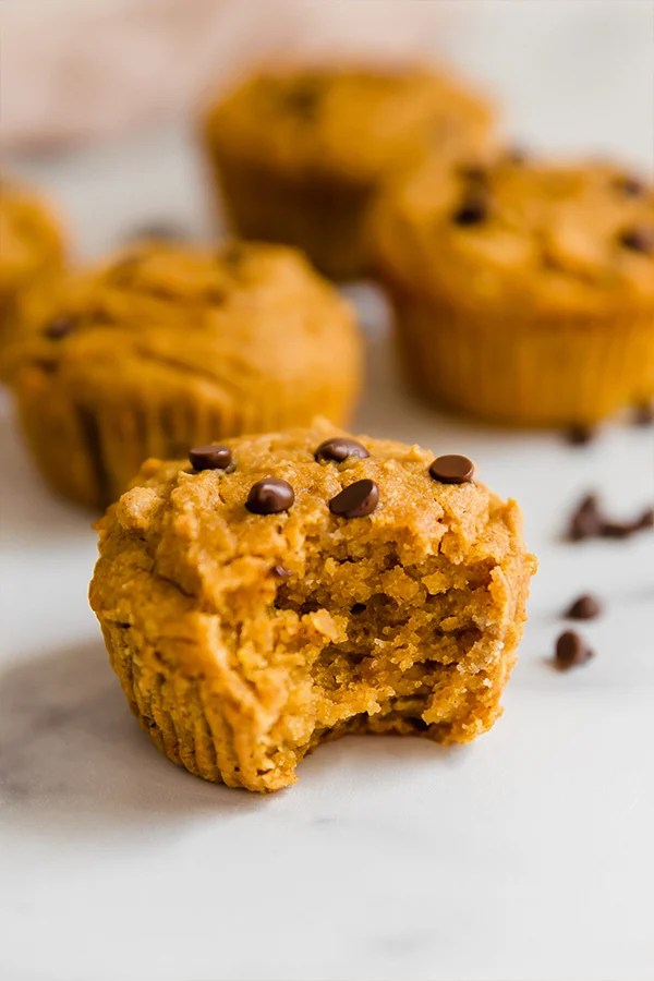 A bite taken out of a paleo pumpkin muffin.