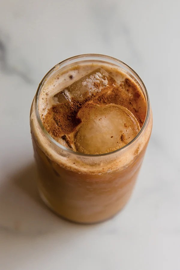 Pumpkin cold brew in a glass with ice.