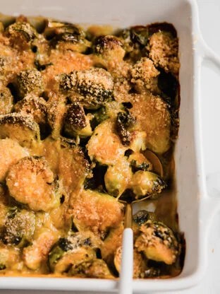 Spoon in a dish of brussels sprouts gratin.