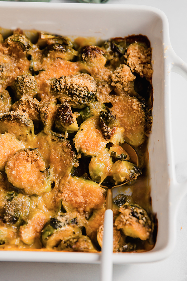 Spoon in a dish of brussels sprouts gratin.