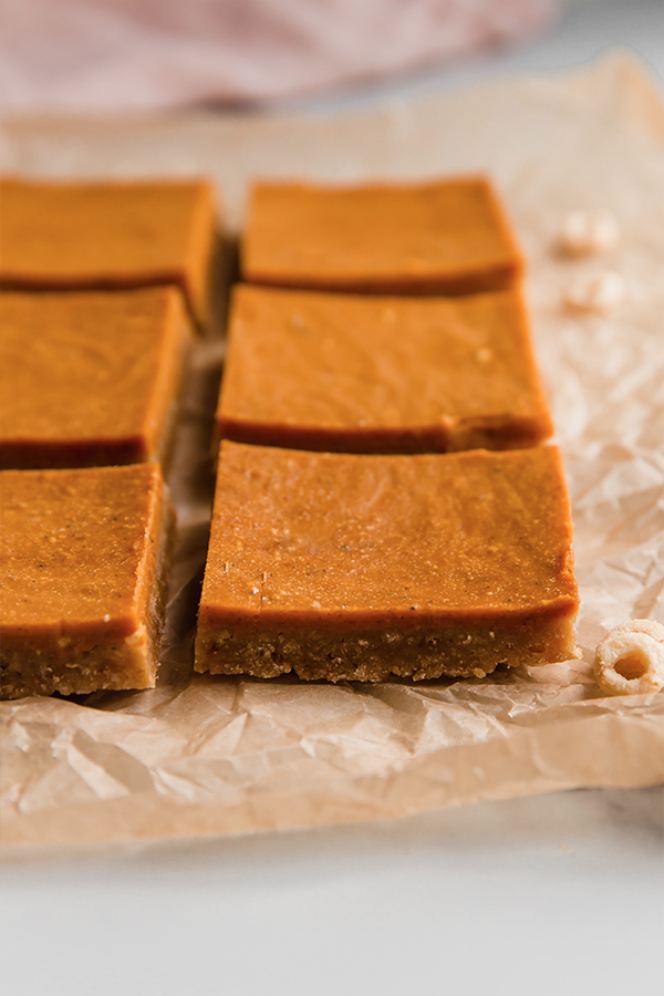 Pumpkin pie bars on parchment paper.