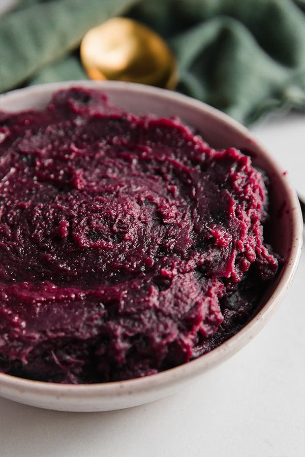 A bowl of purple mashed sweet potatoes.