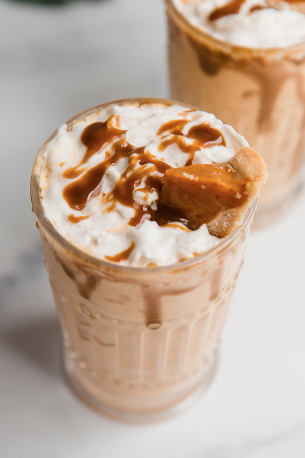 Tall glass filled with pumpkin pie milkshake.