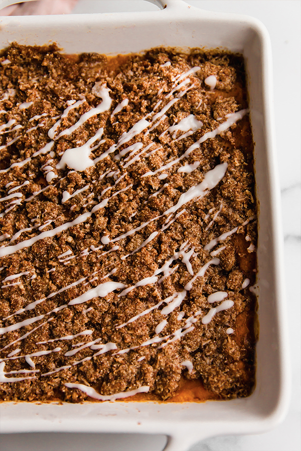 Baking dish of sweet potato casserole with streusel topping.
