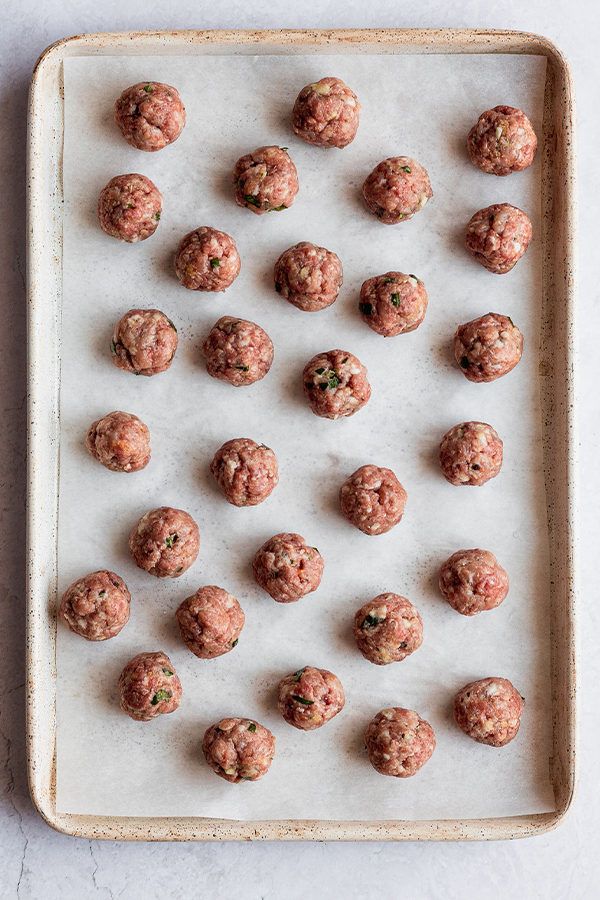 Meatballs on a baking sheet.