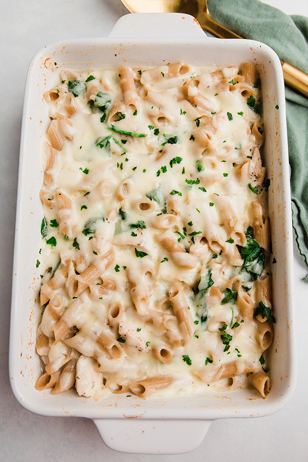 A baking dish of chicken alfredo no-boil pasta bake.