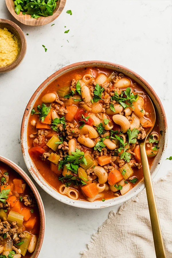 Bowl of pasta fagioli soup with a spoon.