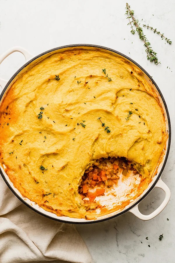 Pan of turkey shepherd\'s pie with a scoop missing.
