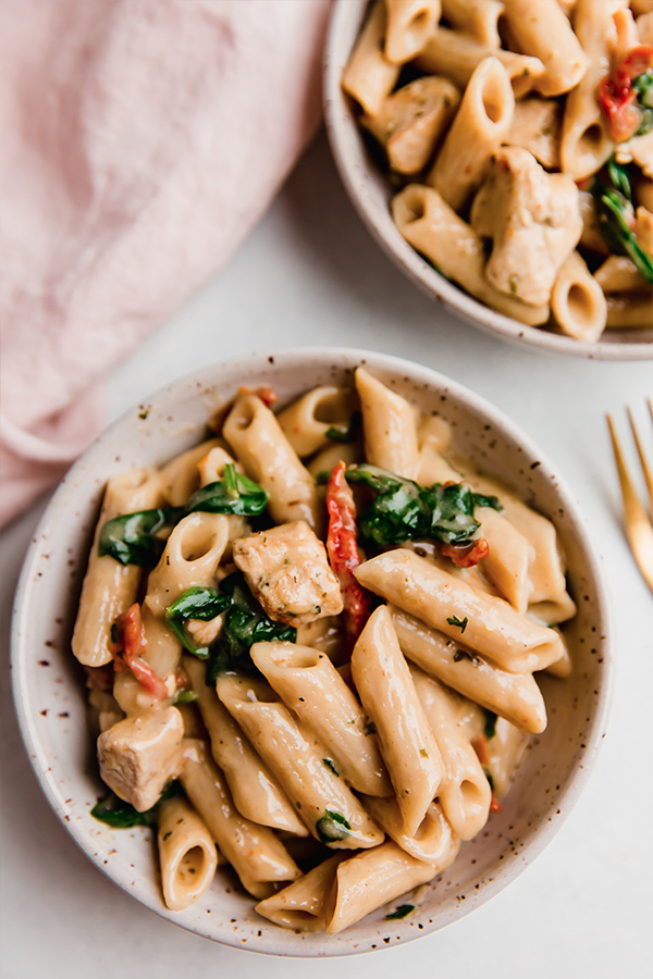 Creamy Tuscan chicken pasta in a dish.