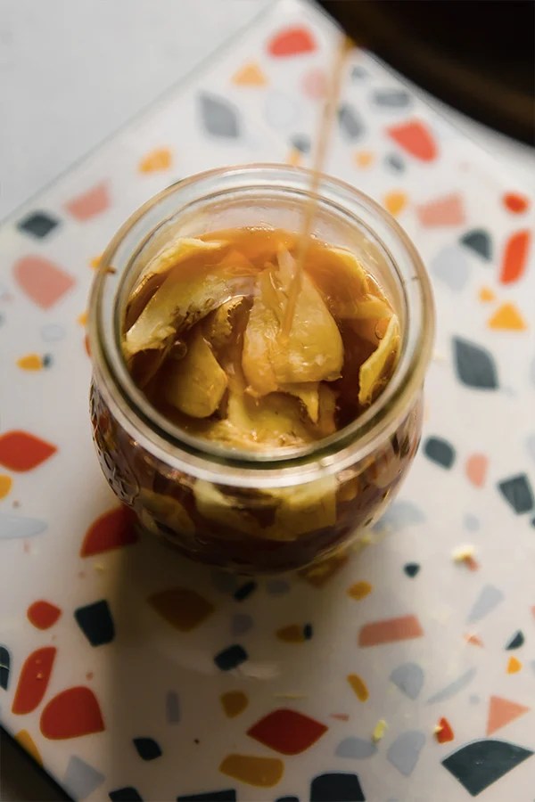 The liquid pouring over the ginger in a jar.