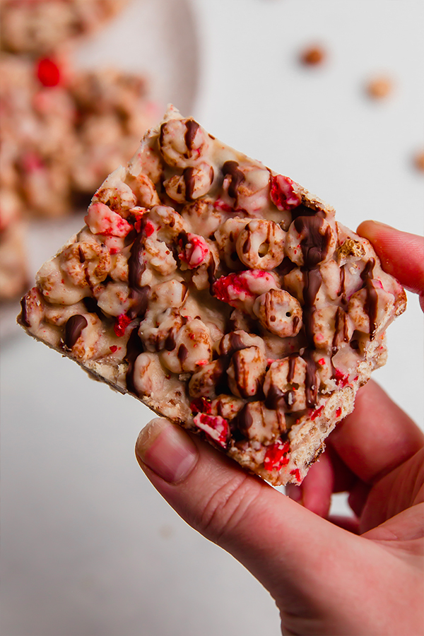 Person holding a strawberry cacao cereal bar.