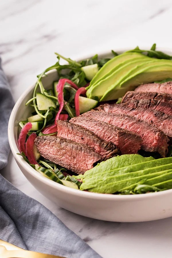 Balsamic steak in a bowl with avocado and vegetables.