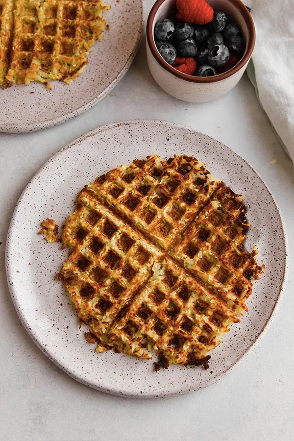 Plate with a sweet potato hashbrown waffle.