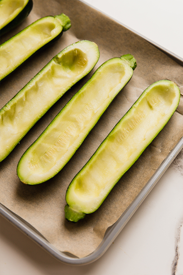 Scooped out zucchini on a baking sheet.