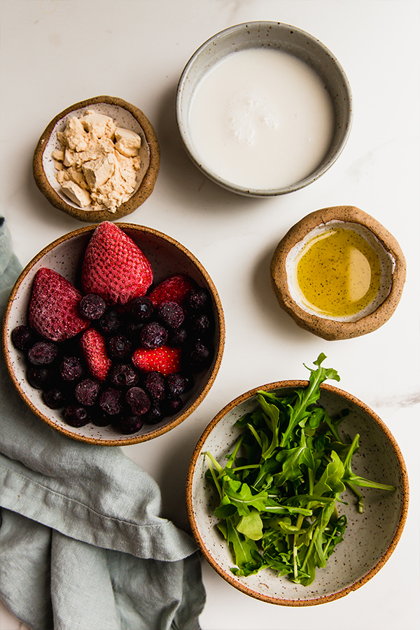 Ingredients including frozen wild blueberries, arugula, and protein powder.