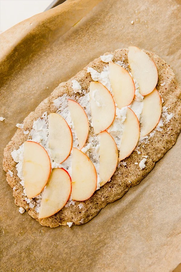 A apple balsamic flatbread with cheese and apples on it.
