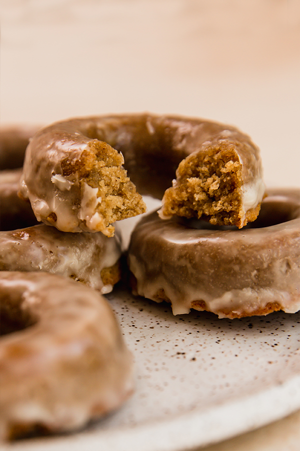 Stacked apple cider donuts with a bite out of one
