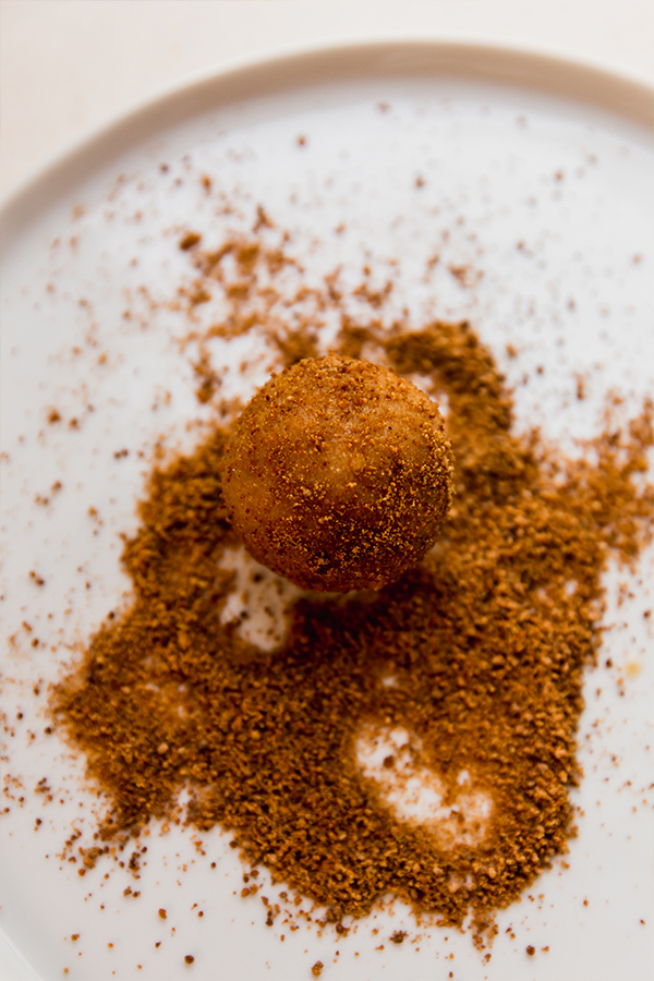 The pumpkin buckeyes rolling in coconut sugar