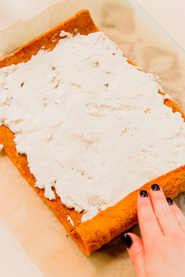 Frosting spread over a pumpkin cake.