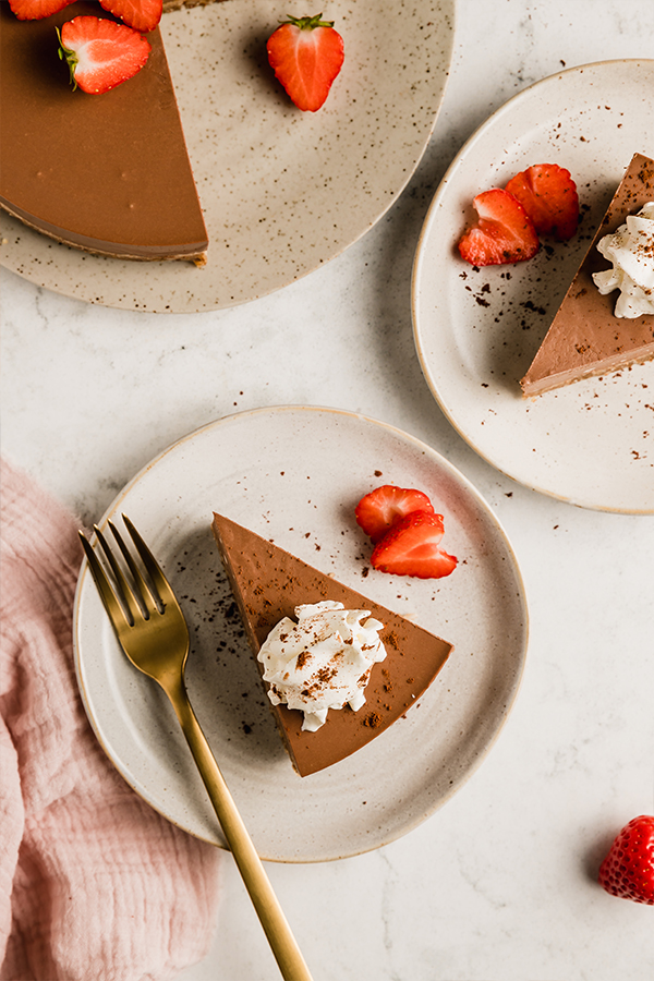 Slice of chocolate pie topped with whipped coconut cream.