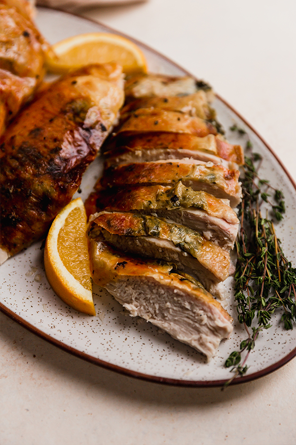 Sliced orange turkey with herbs.