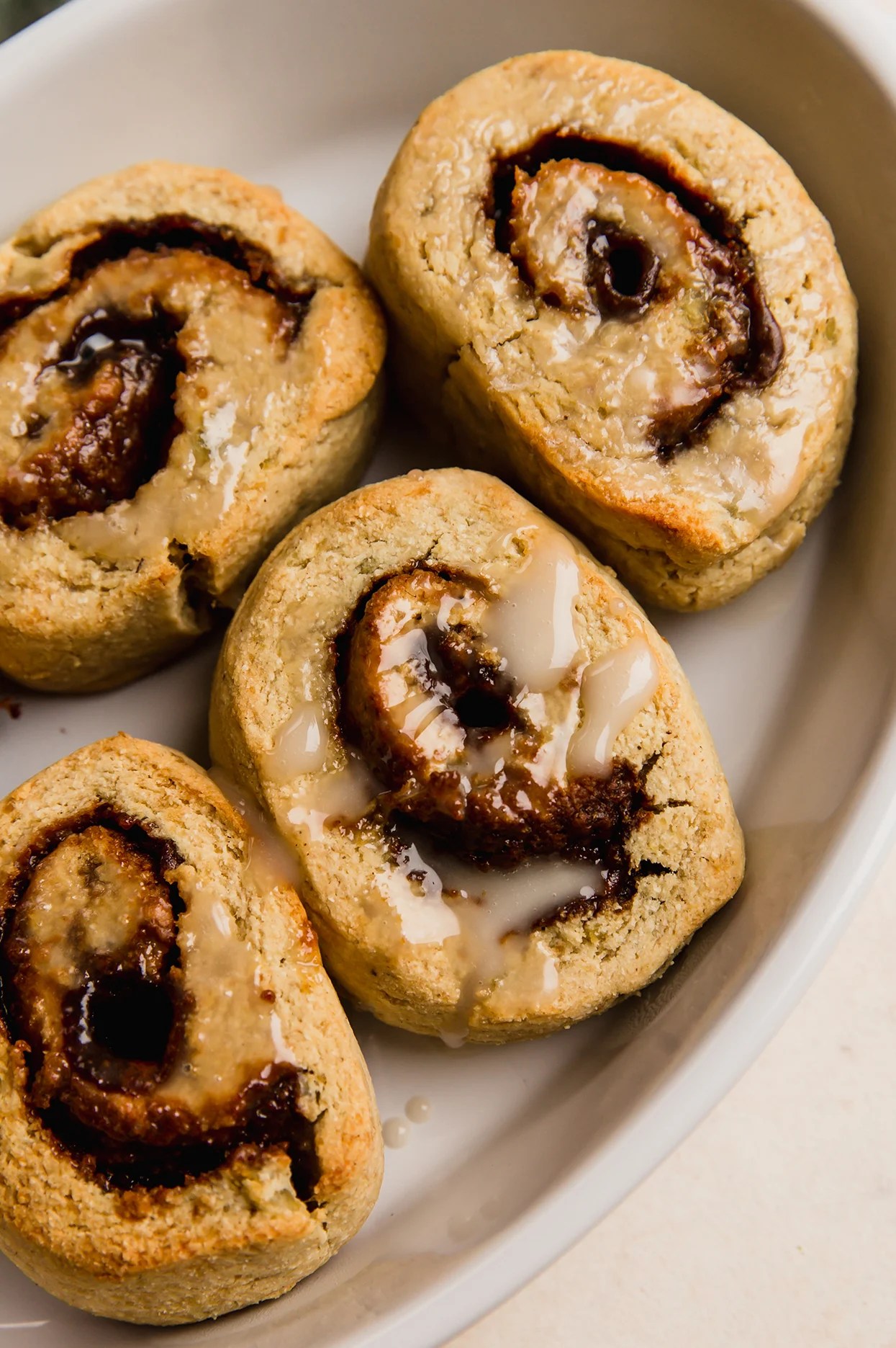 Gingerbread cinnamon rolls in a baking tray.