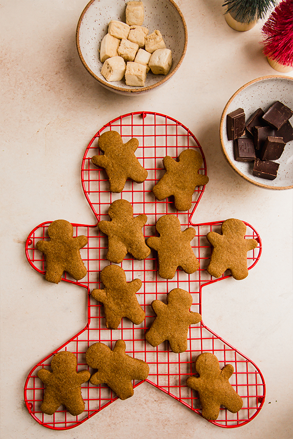 Gingerbread cookies cooling on a cooling rack.