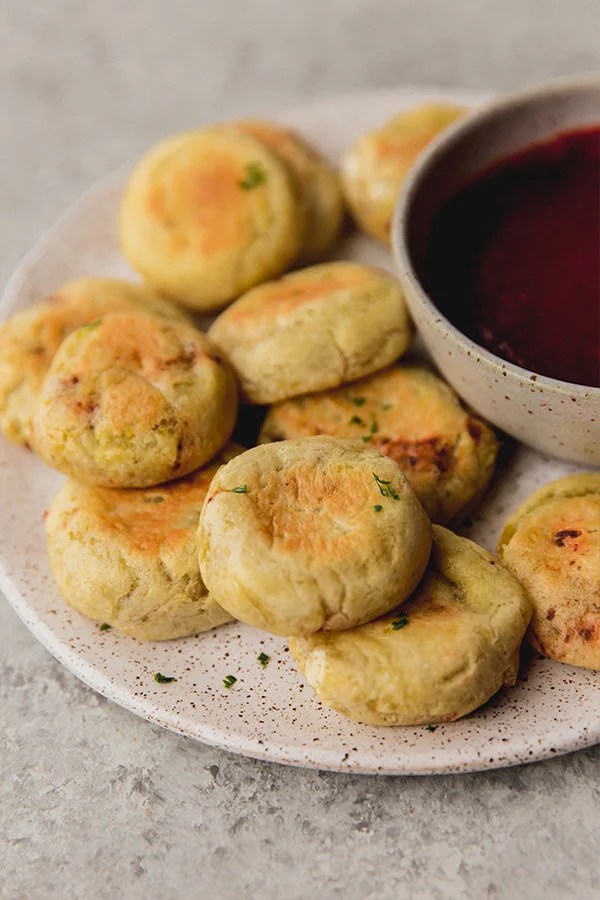 AIP pizza bites on a plate with a bowl of dip.