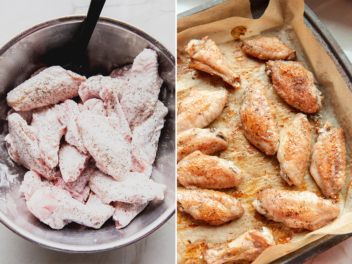 Seasoned wings being cooked on a lined baking sheet.