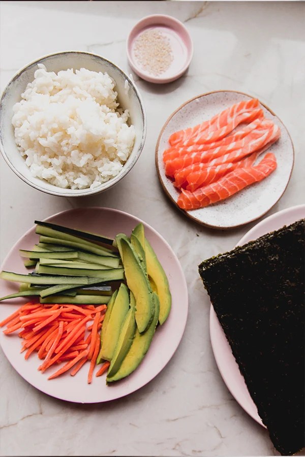 Ingredients including sushi rice, avocado, and sesame seeds.